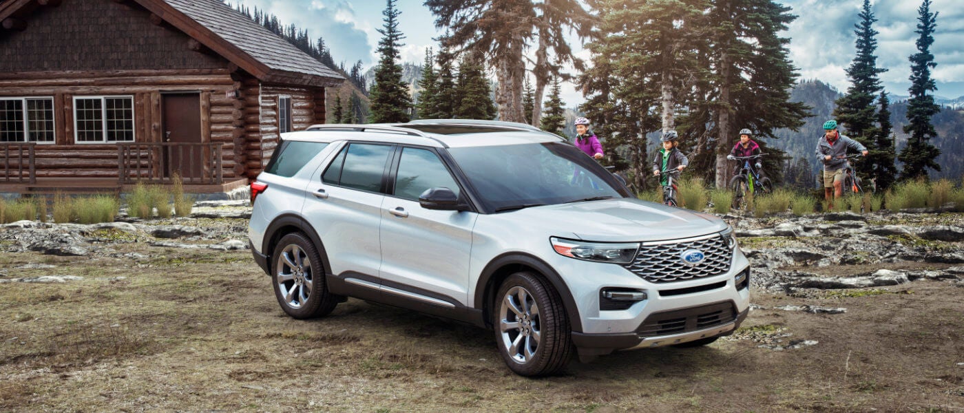 2024 Ford Explorer parked outside a cabin in the woods